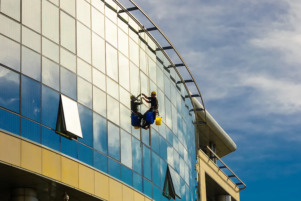 industrial-climber-washes-mirror-glass-modern-building (1)